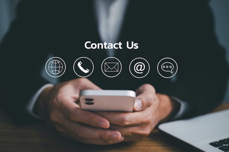 Contact us or Customer support hotline people connect. Businessman using a mobile phone with the email, call phone, address, Chat message icons.
