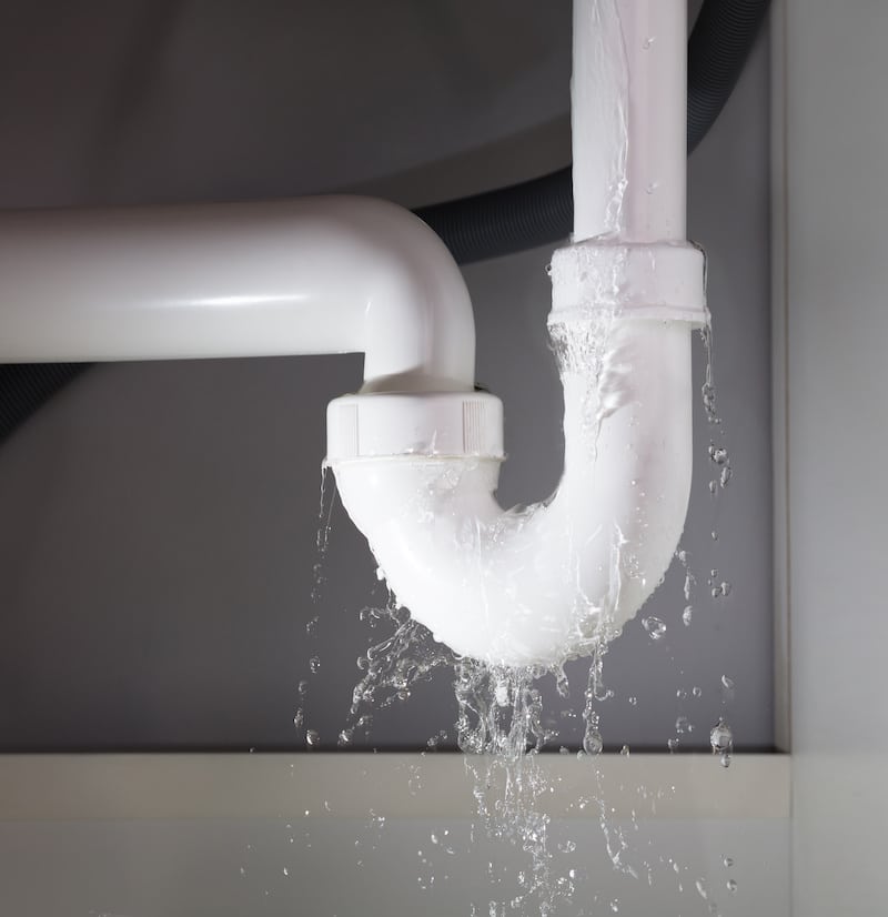 Close-up Of Water Is Leaking From The White Sink Pipe