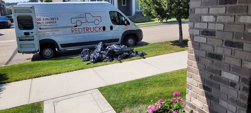 Red Truck Outside a home with Water Damage