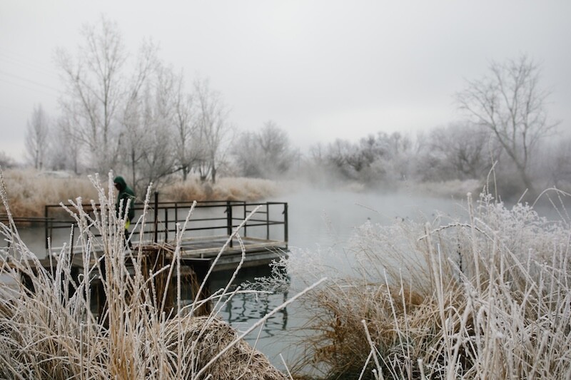 A fisherman on a dock on a cold winter morning in Nampa, Idaho