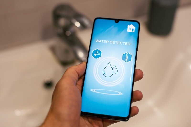 Smart Home: Man Controlling Heating Using App. High quality photo