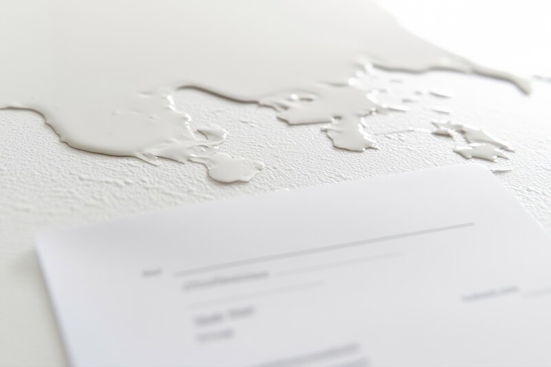 Wet patches stain the ceiling, indicating significant water damage. A repair invoice lies on the surface, detailing costs and services needed for restoration.