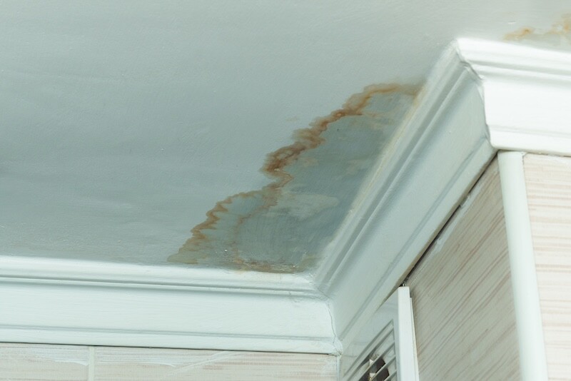 Neighbors have a water leak, water-damaged ceiling, close-up of a stain on the ceiling.