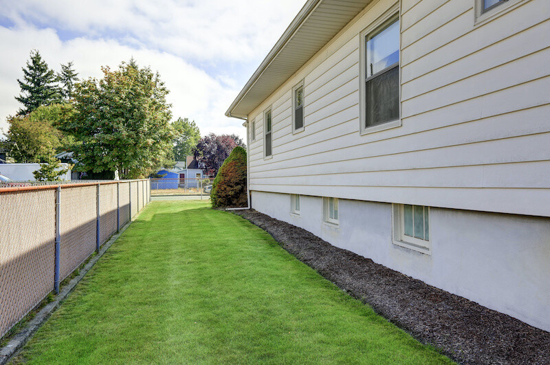 House exterior. View of side wall and green grass. Northwest, USA