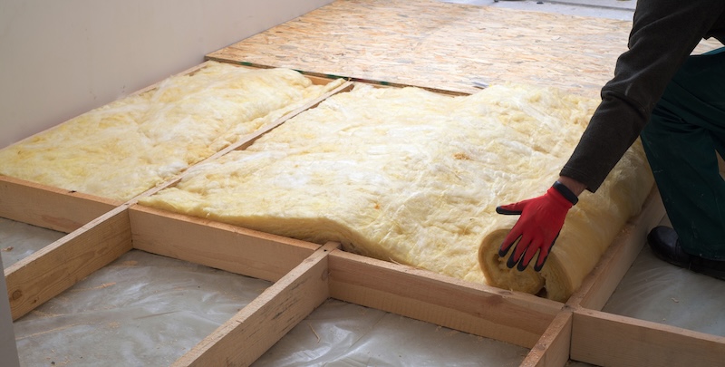 Work composed of mineral wool insulation in the floor, floor heating insulation , warm house, eco-friendly insulation, a builder at work KPOT C.B..