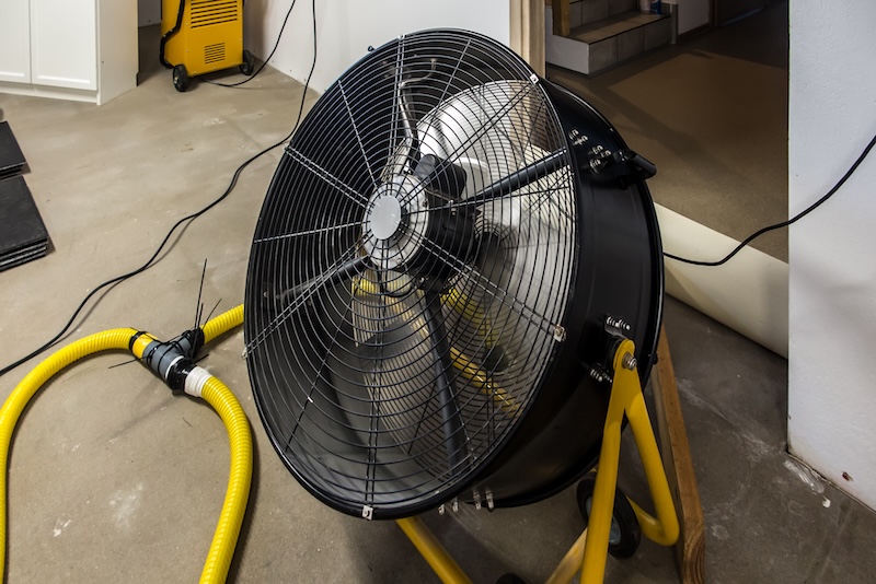 Drying a concrete floor under a fabric covering. After pouring, initial drying, and then drilling and blowing hot air into the heating zone and drying the outgoing air.