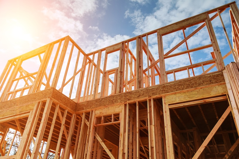New residential construction home framing against a blue sky. Roofing construction. Wooden construction SSUCv3H4sIAAAAAAAEAH1RTUvEMBS8C/6HknOL7SabpR71JAj+gMXDa5KtoWki+ViRpf/dpGklB/HWmXkzffNyu7+rKjSAkww9VreEIpZKBecteGl0pNt64wWX3lgJKpGJW1YFOQ8+OOFSxEYx8GKMs5nc/Pt/zhlXu7CK0REl9BSk4lKP7uEVNJ/BTg7VxZgLQxp7C54bY9GuLPU/mS+apz5p8T+ino2OYmBr29+8/PG+V4dRaPa9FiyKW6EE5OLnPIqmLy/sXJ7iKrkwBYbApSmucjUMVDLgIvnTShavUNiM/xC2vHCsZOaC0Mavm6BcEvH4BAl2uDtS0ncUE0pbeug6tD+bYZPk5a6SJwfrh1acyKk5Eo4bQi6iGTAmDT/0AAOQC+5pvNTyA0GkbkM+AgAA